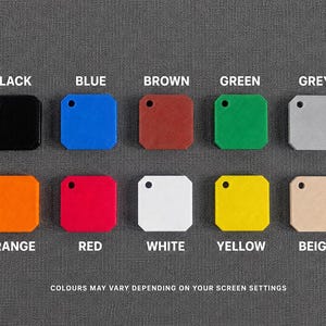 May include: Ten square tags with rounded corners and a single hole in the top left corner, arranged in two rows. The colors are black, blue, brown, green, grey, orange, red, white, yellow, and beige. Text labels identify each color accordingly.