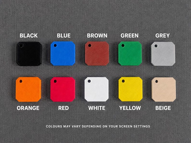 May include: Ten square tags with rounded corners and a single hole in the top left corner, arranged in two rows. The colors are black, blue, brown, green, grey, orange, red, white, yellow, and beige. Text labels identify each color accordingly.