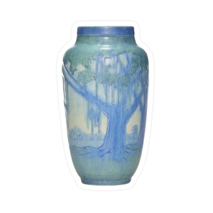 May include: A ceramic vase with a blue and green glaze. The vase features a detailed illustration of a tree with hanging moss. The tree is painted in shades of blue against a light background. The vase has a wide body and a narrow neck.