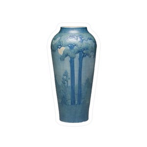 May include: A tall, blue ceramic vase with a landscape design. The vase features a light blue base with darker blue trees and foliage. The top rim is a lighter shade of blue.