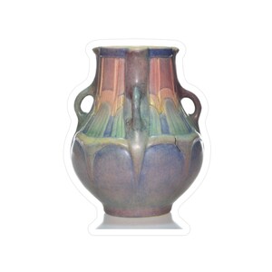 May include: A decorative ceramic vase with a bulbous body and two loop handles. The vase features a colour palette of muted pink, blue, green, and purple hues. The design includes vertical stripes and a floral-like pattern. The vase is approximately 20 cm tall.