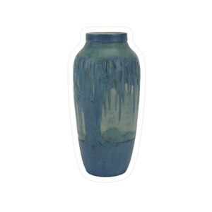 May include: A tall, blue ceramic vase with a textured, dripped glaze effect. The vase features a gradient of blue hues, with darker shades at the base and rim, and lighter, almost white, streaks cascading down the sides. A decorative home decor item.