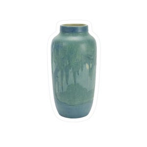 May include: A tall ceramic vase with a rounded body and a narrow neck. The vase has a two-tone colour scheme, with a darker blue base and a teal-green upper section. The glaze has a dripped effect, adding visual interest.