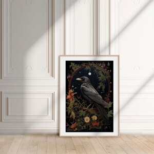 May include: A framed print of a black crow perched on a branch with flowers and leaves. The background is a dark blue with stars and a moon.