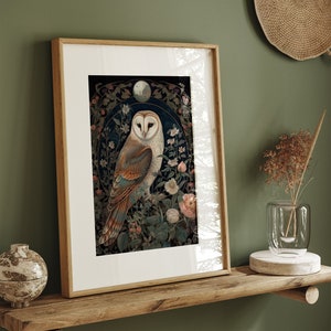 May include: Framed art print featuring a detailed illustration of a barn owl perched amidst floral elements. The owl has a white face and brown and tan feathers. The artwork is set against a dark background with a light-colored frame, creating a nature-inspired aesthetic.