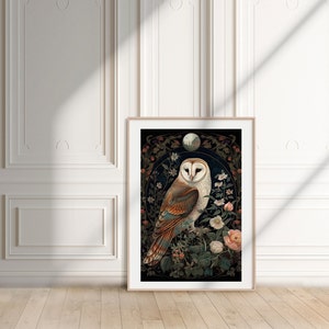 May include: Framed art print featuring a detailed illustration of a barn owl perched on a flowering branch. The owl has white, brown, and tan feathers, set against a dark background with floral and moon details. The artwork is displayed in a light wood frame.