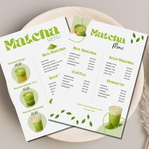 May include: Two matcha menu flyers on a wooden plate. The menus list matcha drinks, coffee, and desserts. The menus have green text and illustrations of matcha drinks. The text includes "Matcha Menu" and drink prices.
