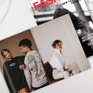 May include: A fashion magazine spread featuring three models. The first page shows two models wearing casual clothing with text on the back of one of the shirts. The second page shows a model wearing a white shirt and white pants sitting on a chair. The magazine cover features the word "FA" in red text and the words "NEW FAS TREND" in black text. The last page features the text "EXCLUSIVE INTERVIEW WITH TAYLOR" in white text.