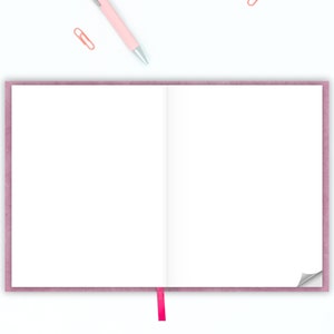 May include: A pink notebook with a white interior and a pink ribbon bookmark. The notebook is open and the pages are blank.