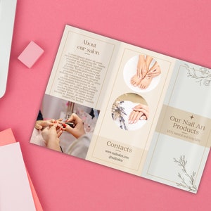 May include: A brochure for a nail salon, featuring images of manicured hands and feet. The brochure has text that reads "About our salon" and "Our Nail Art Products 100% natural and recyclable". The brochure is on a pink surface.