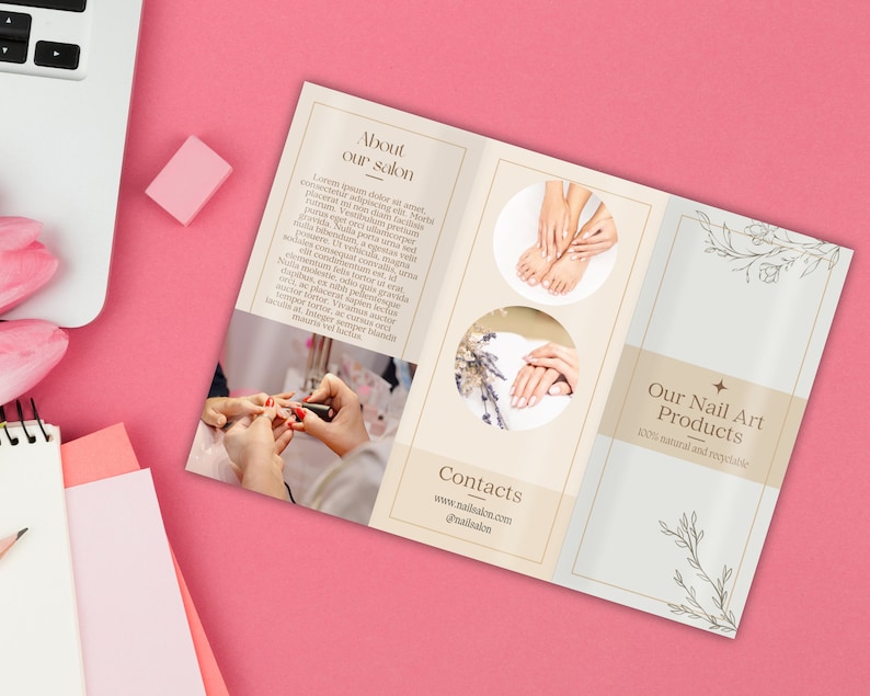 May include: A brochure for a nail salon, featuring images of manicured hands and feet. The brochure has text that reads "About our salon" and "Our Nail Art Products 100% natural and recyclable". The brochure is on a pink surface.