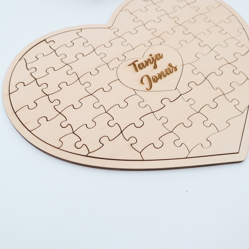 May include: A wooden heart-shaped jigsaw puzzle with a cutout in the centre that says "Tanja Jonas".