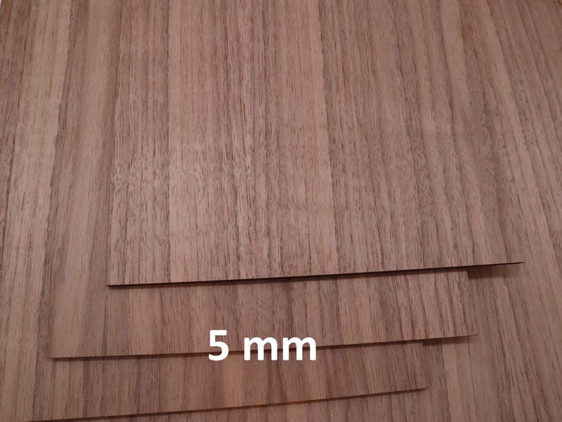 May include: Three pieces of wood veneer, each 5 mm thick, with a brown wood grain pattern.
