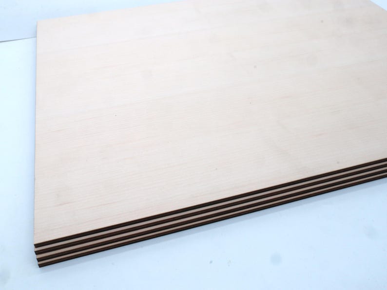 May include: A stack of four sheets of light brown plywood with a smooth surface.