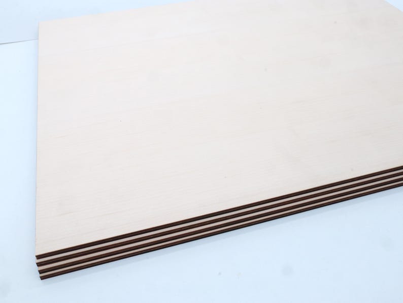 May include: Stack of four unfinished, light brown plywood sheets with a smooth surface.