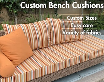 May include: Custom bench cushions with striped fabric in orange, brown, and white. The cushions are on a wicker bench. The text "Custom Sizes", "Easy care", and "Variety of fabrics" is visible in the image.