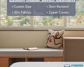 May include: A bench cushion with the text "Custom Indoor Bench Cushions". Features include custom size, stain resistance, 50+ fabrics, and zipper covers. A decorative pillow with a black and pink design rests on the bench.