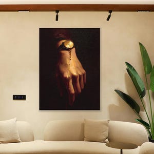 May include: An interior shot features a modern living room with a beige curved sofa, a colorful rug, and a large artwork depicting a hand with a gold watch. The artwork is the focal point, with a dark background and a surreal, melting effect.