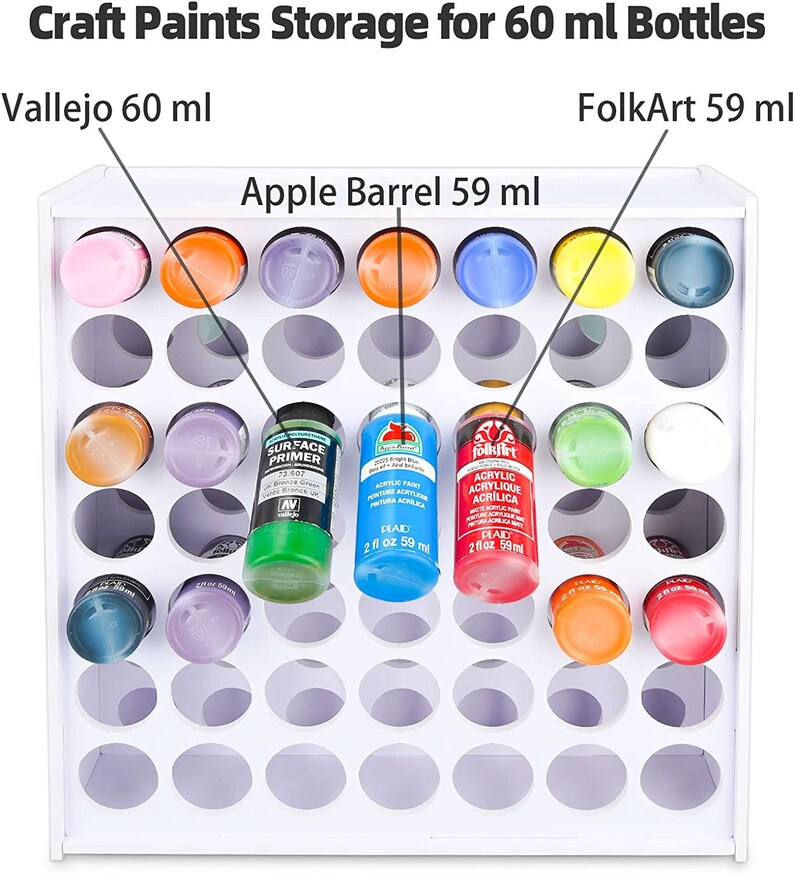 May include: White paint storage rack with 36 round holes for holding 60 ml bottles of paint. The rack is labeled with the text "Craft Paints Storage for 60 ml Bottles".  The rack is also labeled with the text "Vallejo 60 ml", "FolkArt 59 ml", and "Apple Barrel 59 ml".