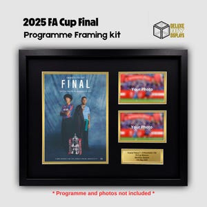 May include: A black framed 2025 FA Cup Final Programme Framing kit. The kit includes space for a program, two photos, and a commemorative plaque. The program features two people and the FA Cup trophy. The text "FINAL" is visible.