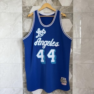 May include: A blue basketball jersey with the words "Los Angeles" in white script and the number "44" in white with a light blue outline. The jersey has white trim around the neck and armholes.