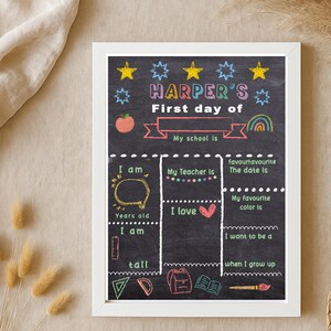 May include: A framed chalkboard-style sign with the text "HARPER'S First day of" and fill-in-the-blank sections for personal details. The design includes colorful illustrations of stars, an apple, and a rainbow.