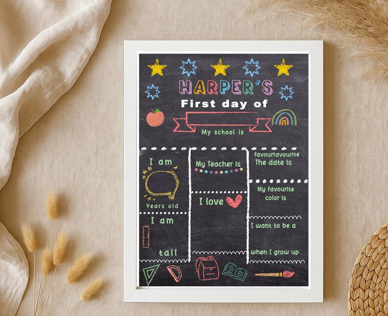 May include: A framed chalkboard-style sign with the text "HARPER'S First day of" and fill-in-the-blank sections for personal details. The design includes colorful illustrations of stars, an apple, and a rainbow.