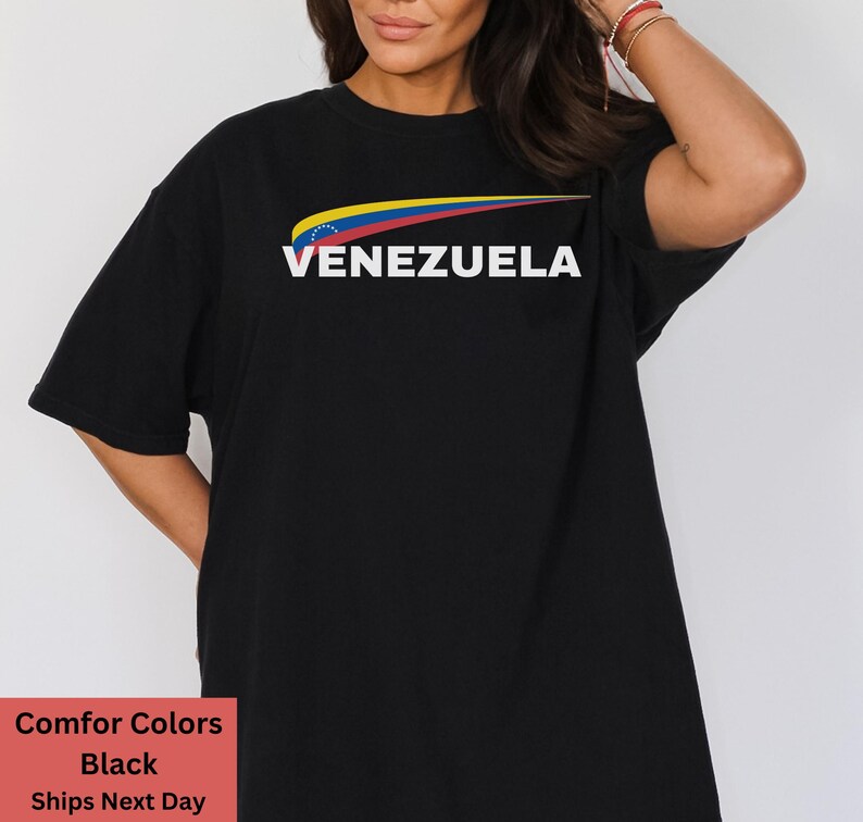 May include: Black t-shirt with a yellow, blue, and red graphic of the Venezuelan flag and the word "VENEZUELA" in white text.