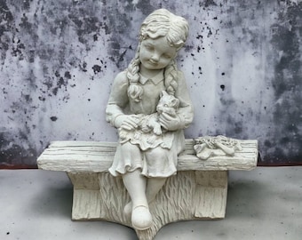 Girl with cat sitting on bench statue Concrete girl with kitten sculpture Outdoor realistic decoration