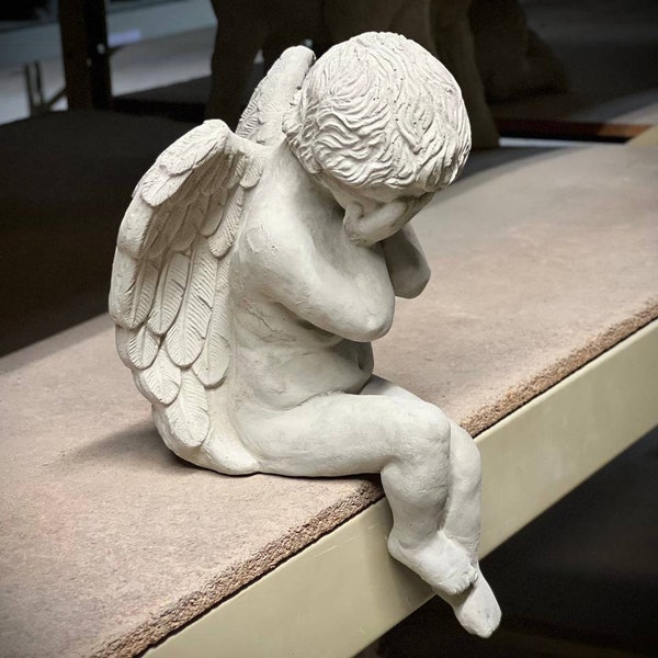 Weeping angel figure Faceless cherub statue Concrete sitting angel hiding face sculpture