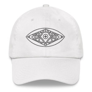 May include: White baseball cap with a black and white geometric eye design.