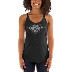 May include: A black tank top with a white graphic of an eye with the text "Shadow of the Talisman" around it.