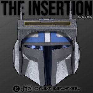 May include: A 3D printed helmet with a blue and gray color scheme. The helmet has a visor and a rectangular panel on the top. The text "THE INSERTION STL FILE" is visible at the top of the image.