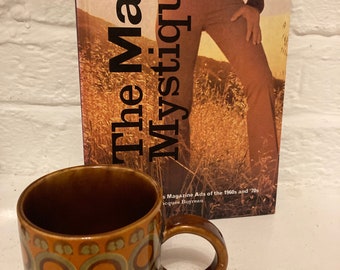 The Male Mystique, hardback vintage Male Advertising book, 1970s Mug, Men’s magazine ads of the 1960s and 1970s, Man cave decor