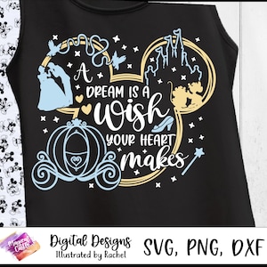 May include: Black tank top with a light blue and gold design featuring a Cinderella theme. The design includes a carriage, castle, and the text "A dream is a wish your heart makes."