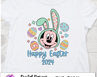 May include: A white t-shirt with a cartoon image of Mickey Mouse wearing bunny ears. Mickey Mouse is surrounded by colorful Easter eggs and stars. The text "Happy Easter 2024" is printed below Mickey Mouse.