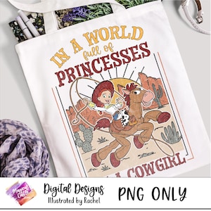 May include: A white tote bag with a colorful graphic design featuring a cartoon cowgirl riding a horse. The text "In a world full of princesses... a cowgirl" is printed on the bag.