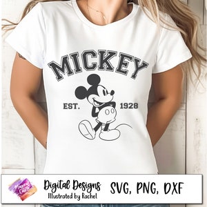 May include: A white t-shirt with a black and white graphic of Mickey Mouse. The graphic includes the text "MICKEY" in a bold font, "EST." and "1928" in a smaller font.