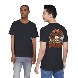 May include: A black t-shirt featuring a graphic on the back. The design shows a cartoon character wearing a firefighter helmet and spraying water from a hose, with a fire truck in the background and the text Professional Hose Handler.