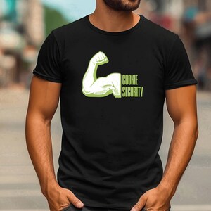 May include: A black t-shirt with a green graphic of a bicep flexing with the text "Cookie Security" underneath.