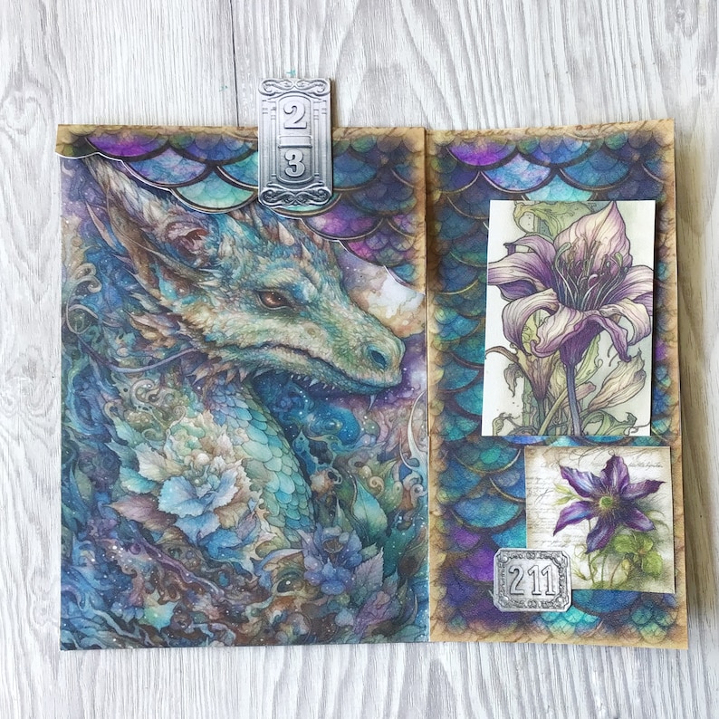 May include: A brown paper envelope with a dragon illustration on the left side and two floral illustrations on the right side. The envelope has a silver metal tag with the numbers "211" on it. The envelope is decorated with a blue and purple scale pattern.