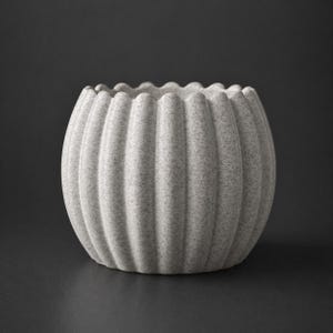 May include: A gray, textured ceramic planter with a ribbed design. The round pot has a scalloped rim and a speckled appearance. The neutral color and simple design make it suitable for various plants and home decor styles.
