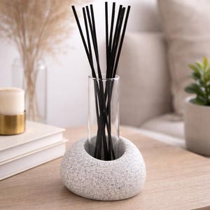 May include: A set of three ceramic mugs with a speckled, matte finish. Each mug features a different color: light blue, cream, and gray. The mugs have a simple, modern design with a rounded shape and a handle.