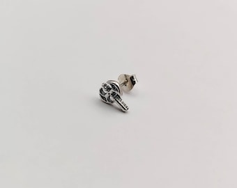 May include: Silver axe earring with a detailed design. The earring is a stud style with a post and a butterfly backing.