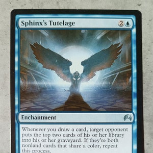 May include: A blue and white Magic: The Gathering card with the text "Sphinx's Tutelage" and an illustration of a winged figure with a glowing halo. The card is an enchantment with the text "Whenever you draw a card, target opponent puts the top two cards of his or her library into his or her graveyard. If they're both nonland cards that share a color, repeat this process. 5: Draw a card, then discard a card. "You've never considered the implications of dealing with another telepath, Jace."