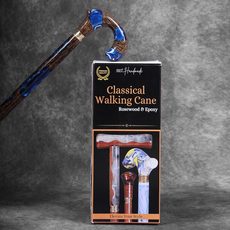 May include: A handcrafted classical walking cane made of rosewood and epoxy. The cane features a curved handle with blue accents and a gold-colored band. The product packaging displays the text "Classical Walking Cane" and "Elevate Your Style."