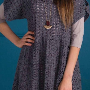 May include: A gray crochet top with a loose fit and a delicate openwork pattern. The top has short sleeves and a round neckline. A gold necklace with a crescent moon pendant hangs from the neckline.