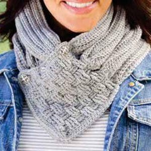 May include: Gray crocheted infinity scarf with a button closure. The scarf is made with a textured stitch pattern.