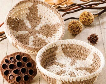 May include: Two crocheted baskets with a brown and white striped pattern. The baskets are made of a natural fiber and have a rustic look.