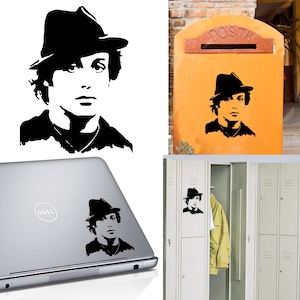 May include: Black and white silhouette of a person wearing a fedora hat. The image is shown on a laptop, a mailbox, and a locker.